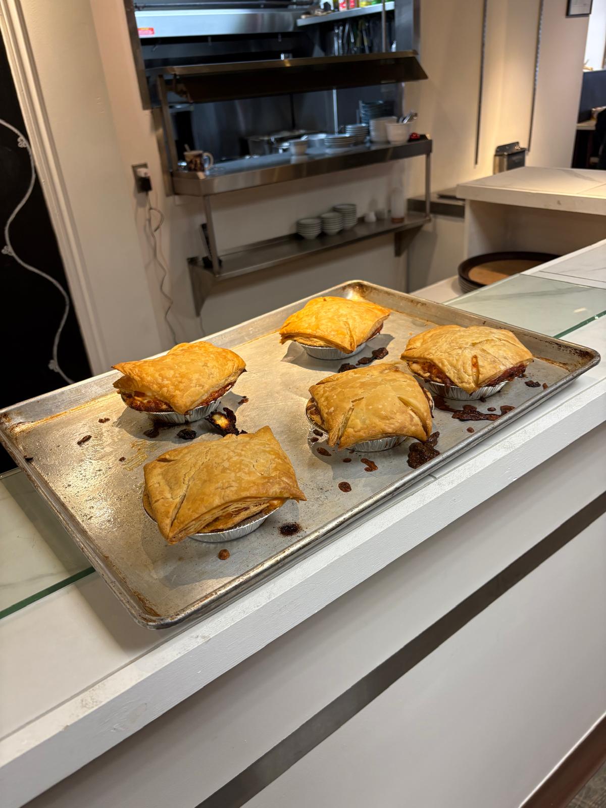 Homemade pot pies with golden puff pastry crust